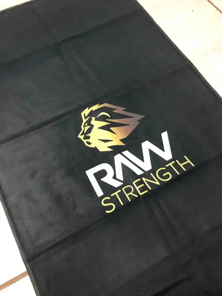 Black Swimdry towel with gold and white Raw Strength branding