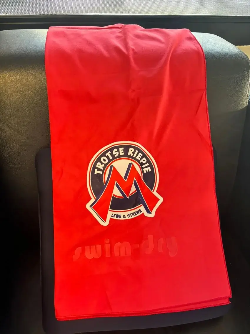 Red Swimdry towel displaying a team crest